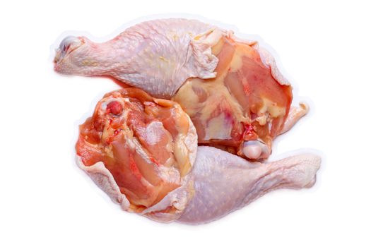 Raw chicken's legs isolated against white background