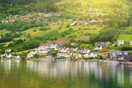 Village houses on mountain slopes. A small village with modern houses by the lake. Environmentally friendly living environment.