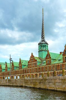 Spire of Borsen building, shaped as the tails of dragons twined together in twiligh. Copenhagen, Denmark. View of the landmark spire of the historic Stock Exchange Copenhagen, Denmark