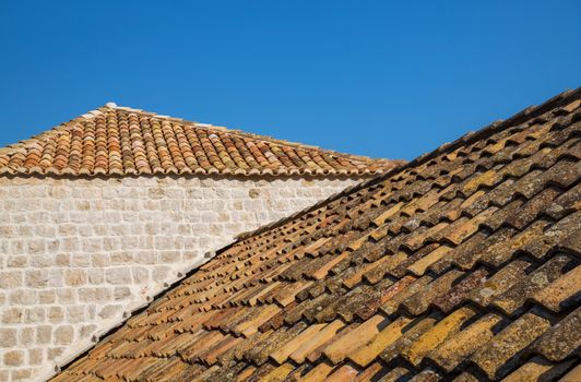 Traditional Mediterranean houses with red tiled roofs and Dubrovnik fortress bastions, Dalmatia, Croatia, Europe.