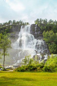 Falls in mountains of Norway in rainy weather. White waterfall. Tvindefossen Waterfall near Voss, Norway. Waterfall in mountains of Norway