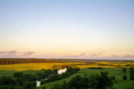 Landscape with river and trees, fields and cloud sunder the sun