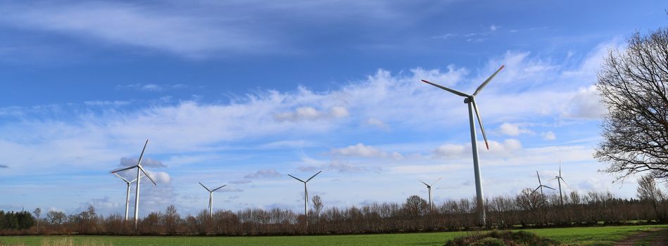 Panoramic view on alternative energy wind mills in a windpark