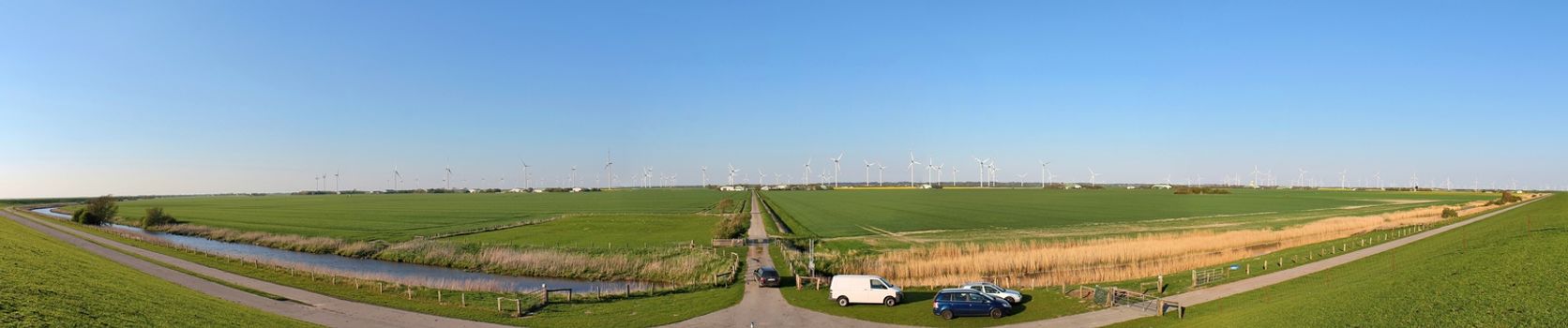 Panoramic view on alternative energy wind mills in a windpark