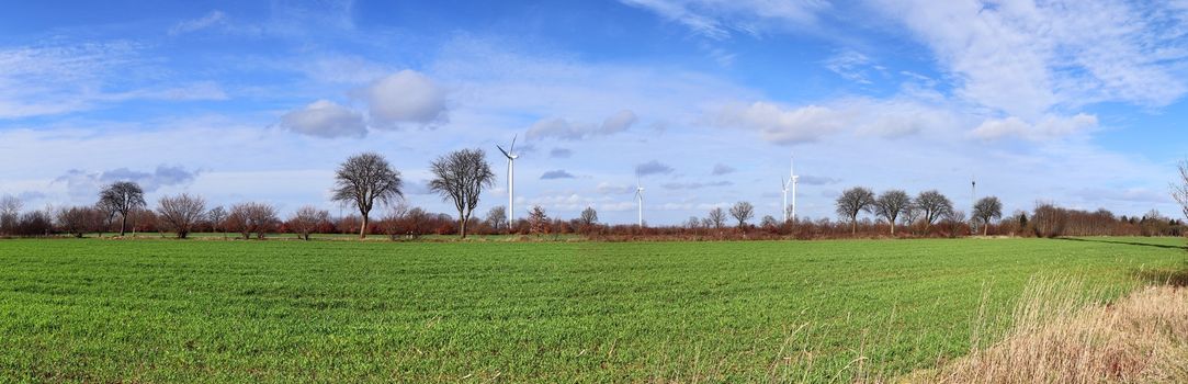 Panoramic view on alternative energy wind mills in a windpark