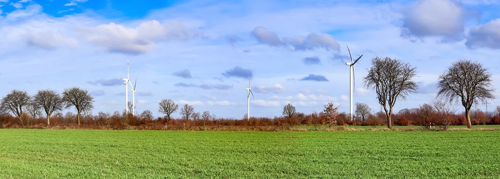 Panoramic view on alternative energy wind mills in a windpark