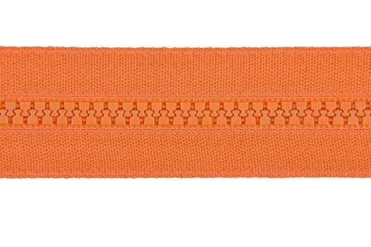 Closed orange zipper isolated on white background. Orange zipper for tailor sewing. View from above