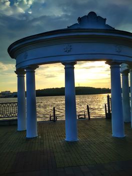 Rotunda on the embankment on a warm evening before sunset. Romance on the quay at the river. Ukraine