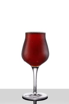 Red ale beer in tulip wineglass isolated on white background.