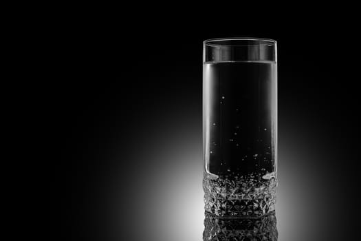 Glass of water on a black background