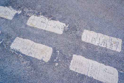 Give way sign on asphalt, detail of a traffic signal at the city, information and road safety