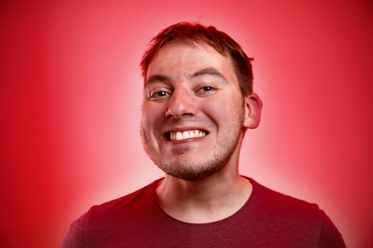 Smiling man on a red background