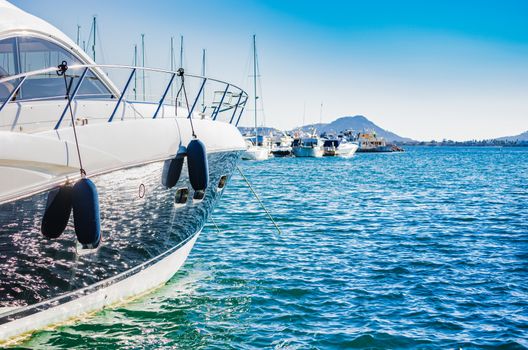 Detail view of anchored luxury motorboat at marina