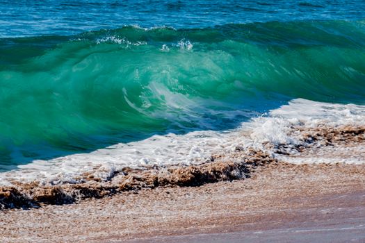 Breaking Surf waves crash in on Tairua beach on Coromandel Peninsula, New Zealand closeup.