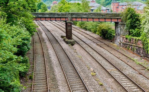 Four railway tracks running under a bridge