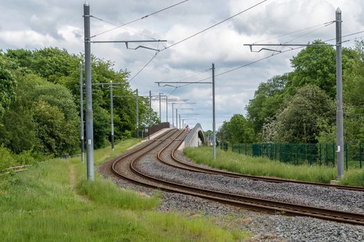 Tram or train tracks with overhead electric wires