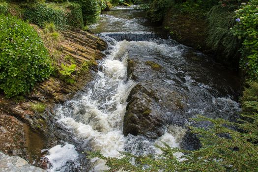 Water cascading over rocks in a river after heavy rainfall