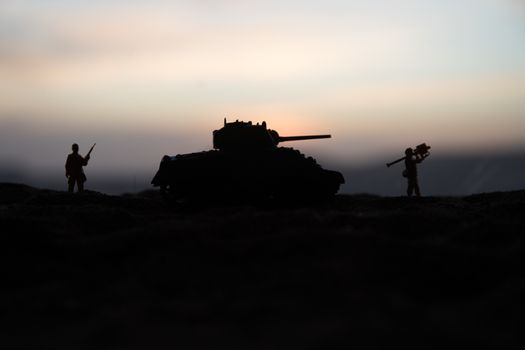 War Concept. Military silhouettes fighting scene on war fog sky background, World War Soldiers Silhouette Below Cloudy Skyline sunset. Selective focus