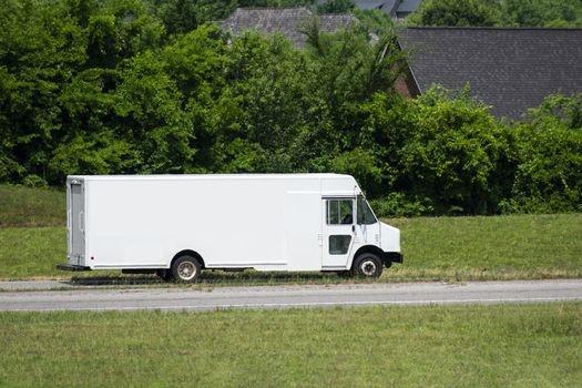 Great copy space on the blank side of this delivery van.  The heat on this hot summer day creates an interesting slight shimmering wave effect on the van and its background.