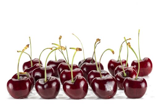 Rows and columns of fresh cherries. Isolated on white background.
