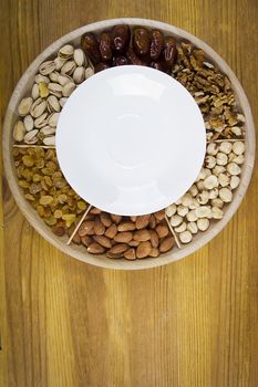 Set of nuts and dried fruits on a wooden table