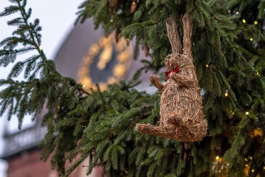 Christmas decorations and lights. In the background clock in church tower.