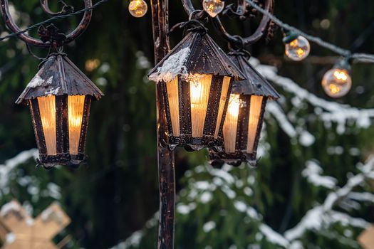 Medieval lanterns with spruce branches at Christmas market. Riga, Latvia - image