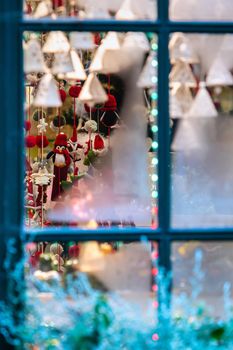 Frozen window panes through which visible Christmas decorations. The concept of Christmas time - image