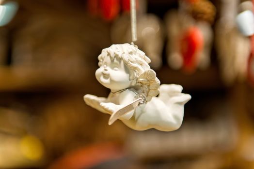 Porcelain angel figure on a blurry background  - image