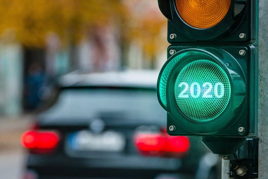 A city crossing with a semaphore. Green light with text 2020 in semaphore. New Year concept - image