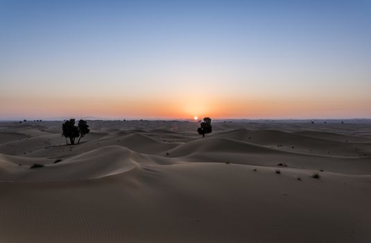 Sun rising above the desert of dunes, Dubai Emirates, United Arab Emirates