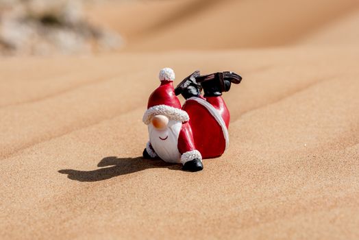 Santa Claus in the desert of sand  enjoying his time