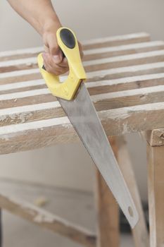 Sawing by the hand saw of wooden whetstone