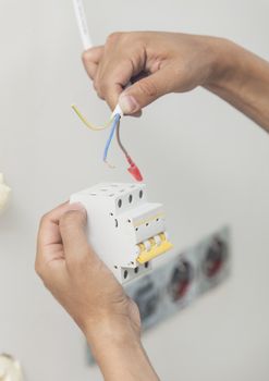An electrician working on a power socket/plug during house renovations.