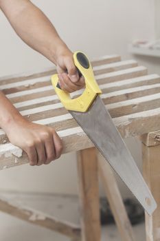 Sawing by the hand saw of wooden whetstone