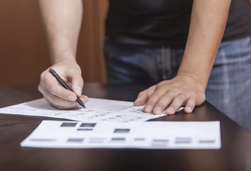 The designer in working process, at a table does sketches by a pencil