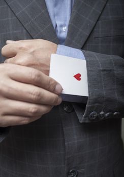 Man's hands close up, hide an ace in a sleeve