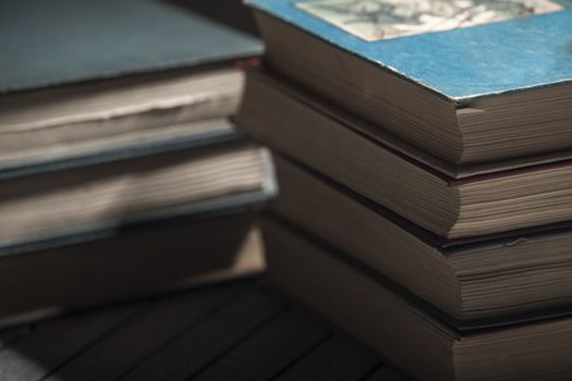 The pile of books lies on a table, a background, other pile, knowledge, library