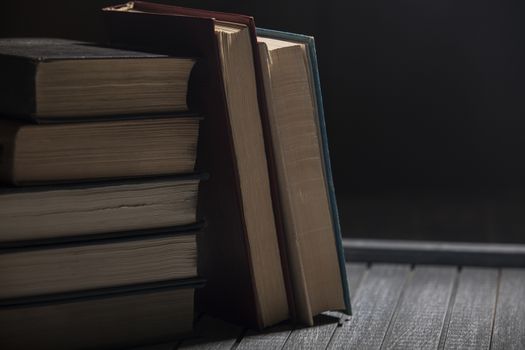 The pile of books lies on a table, a background, other pile, knowledge, library