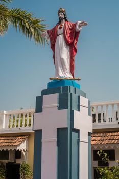 Figurine sacred standing on an apostoment against church