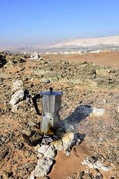 Italian Coffee maker at a fireplace in the desert