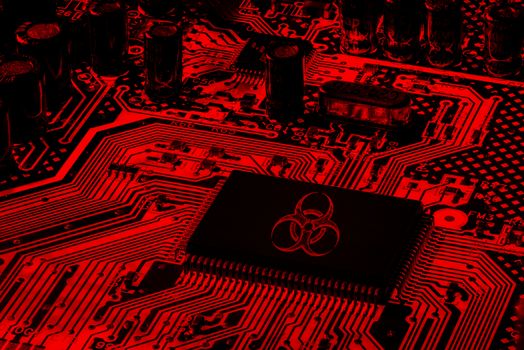 Red Computer Motherboard with biohazard logo, virus ransomware and spamware attack concept