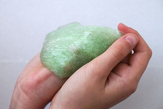 green slime in a child's hand close up