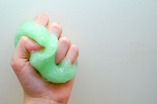 green slime in a child's hand close up