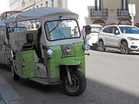 Green Tuktuk in Lisbon in Portugal