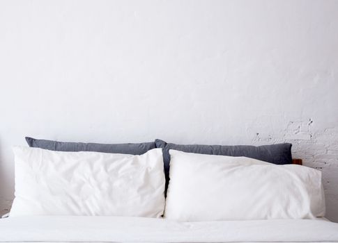 White pillow on bed decoration in bedroom interior.
