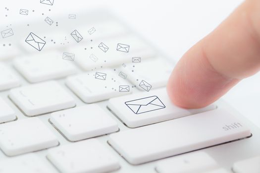 Sending email. gesture of finger pressing send button on a computer keyboard.