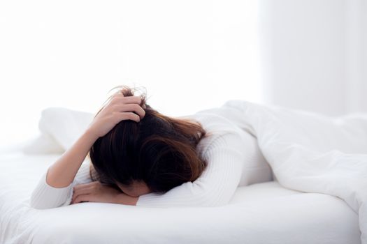 girl with tired for work on bed sleeping at home in the bedroom - woman want leisure for healthcare concept.