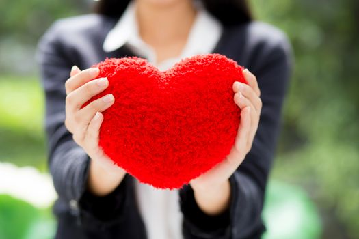 Red heart in businesswoman hand - Asian woman with hope concept.