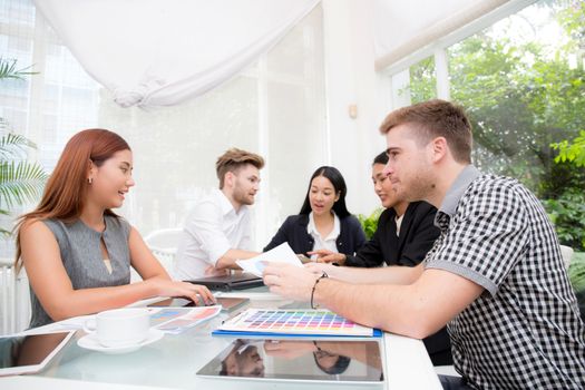 Group of business people brainstorming together in the meeting room.